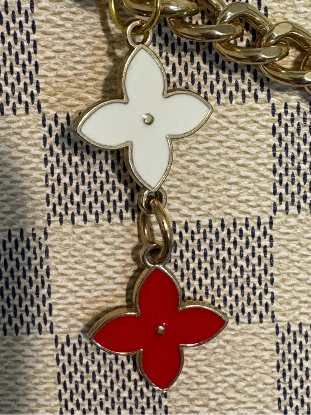 Authentic Louis Vuitton Lock Charm and other unbranded charms on bag chain